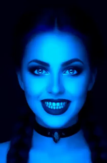 Video preview: Blue neon portrait — An adult woman looks toward the camera under vivid blue light, high-contrast futuristic portrait styling.