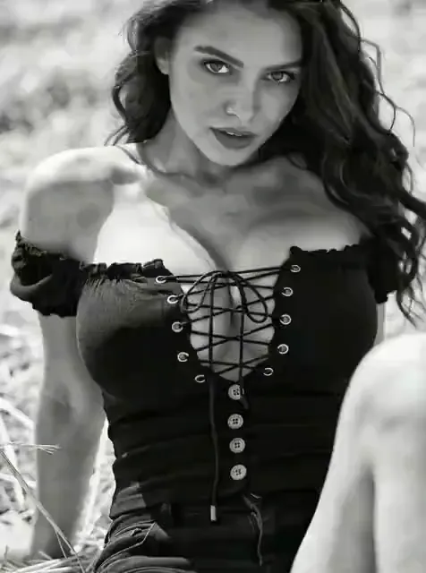 Video preview: Monochrome fashion portrait — An adult woman in a black lace-up dress poses in a black-and-white fashion scene, with soft light and gentle movement.