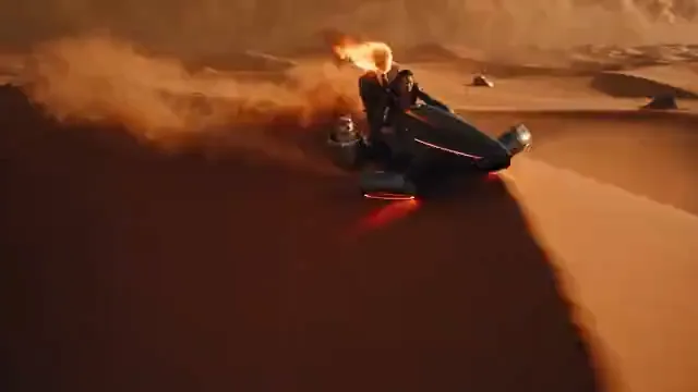 Video preview: Orange desert science fiction — A futuristic armored figure moves across orange desert sand, surrounded by drifting dust and warm cinematic light.